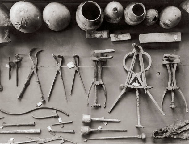 An array of ancient Roman surgical instruments discovered at Pompeii, on display at Naples Museum, circa 1910. (Photo by Hulton Archive/Getty Images)