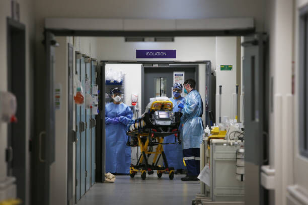 SYDNEY, AUSTRALIA - JUNE 04: Emergency Medicine Specialist Dr Kevin Maruno and medical team take a suspected COVID-19 patient in to the isolation ward in the Red zone of the Emergency Department at St Vincent