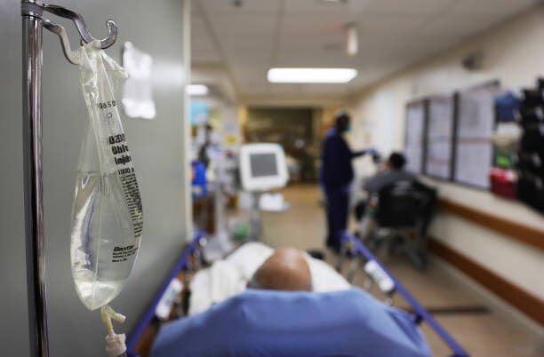 APPLE VALLEY, CALIFORNIA - JANUARY 27: (EDITORIAL USE ONLY) Patients rest in a hallway in the overloaded Emergency Room area at Providence St. Mary Medical Center on January 27, 2021 in Apple Valley, California. The hospital was treating over 170 COVID-19 patients at the peak of the surge but has seen a recent decrease and is currently caring for 87 confirmed or suspected coronavirus patients. California has eased lockdown orders amid fears of a new coronavirus variant. (Photo by Mario Tama/Getty Images)