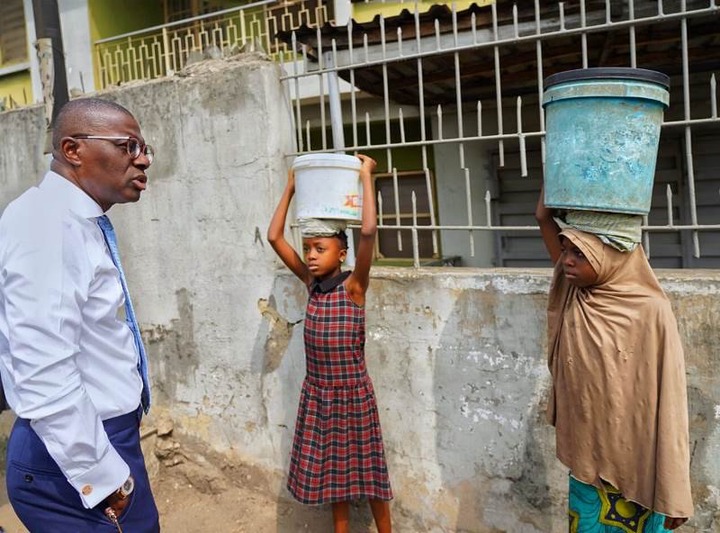 Lagos State Governor, Mr. Babajide Sanwo-Olu having a conversation with the two underage girls to find out the reason they were not in school.