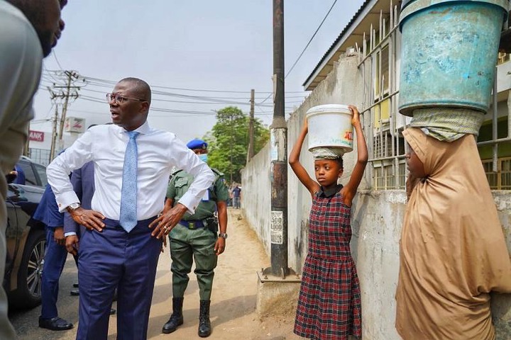 Lagos State Governor, Mr. Babajide Sanwo-Olu having a conversation with the two underage girls to find out the reason they were not in school.