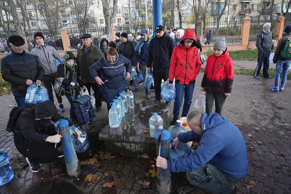 People stand in line to fill containers with water from public water pumps in Kyiv, Ukraine, Monday, Oct. 31, 2022 (Photo: AP/Sam Mednick)