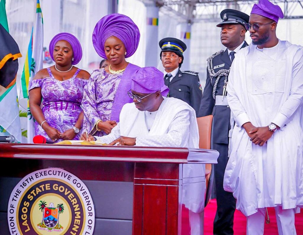 Lagos State Governor, Babajide Sanwo-Olu signing the Oath of Office for his second term in office in the presence of his family on Monday, May 29, 2023