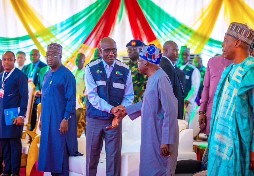 President Bola Tinubu and Group CEO of NNPCL, Malam Mele Kyari exchange pleasantries at the groundbreaking ceremony of the Gwagwalada IPP project