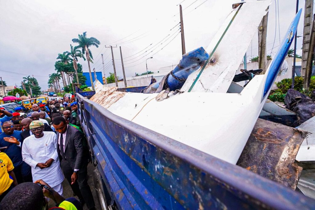 Lagos State Governor, Mr. Babajide Sanwo-Olu, walking past a truck carrying wreckage of the aircraft