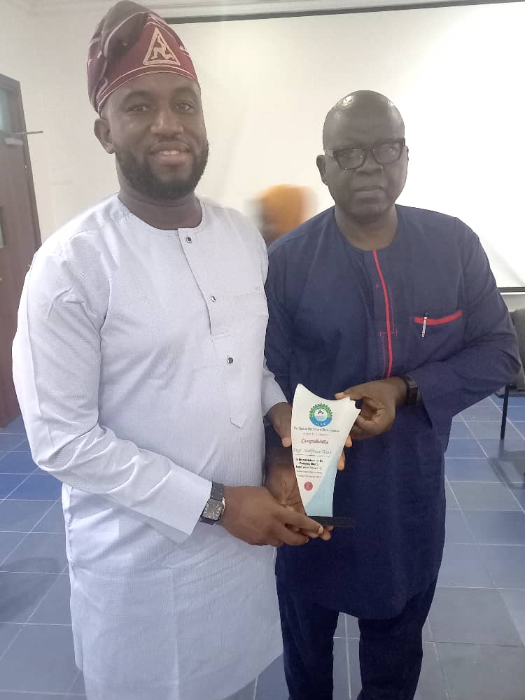 NIWE Chairman, Ibrahim Yinusa Abiodun, presents a plaque to LWC MD, Engr. Mukhtaar Temitope Tijani, during the courtesy visit