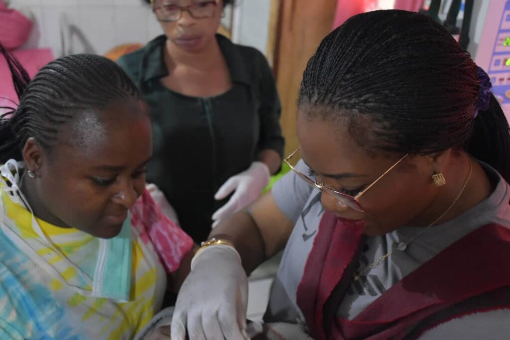 Mandate Secretary of FCT HSES, Dr Adedolapo Fasawe, with a mother, Joyce Emmanuel, at the Gwarinpa General Hospital