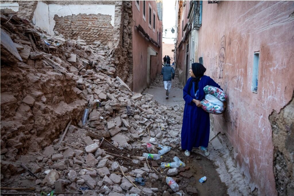 A woman looks at the rubble of a building. Fadel Senna/AFP/Getty Images