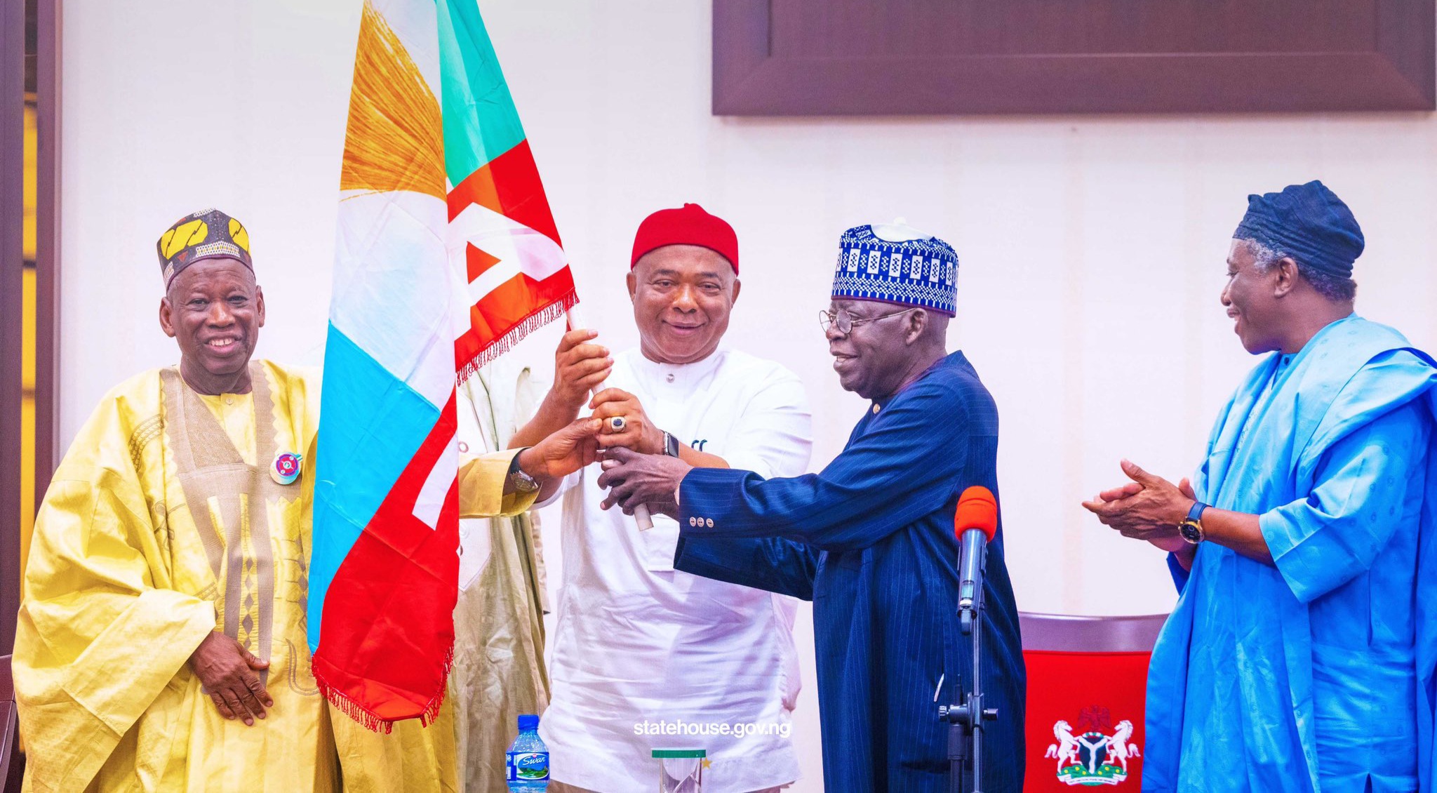 President Bola Tinubu hands the APC flag to the party's governorship candidate in Imo State, Governor Hope Uzodinma