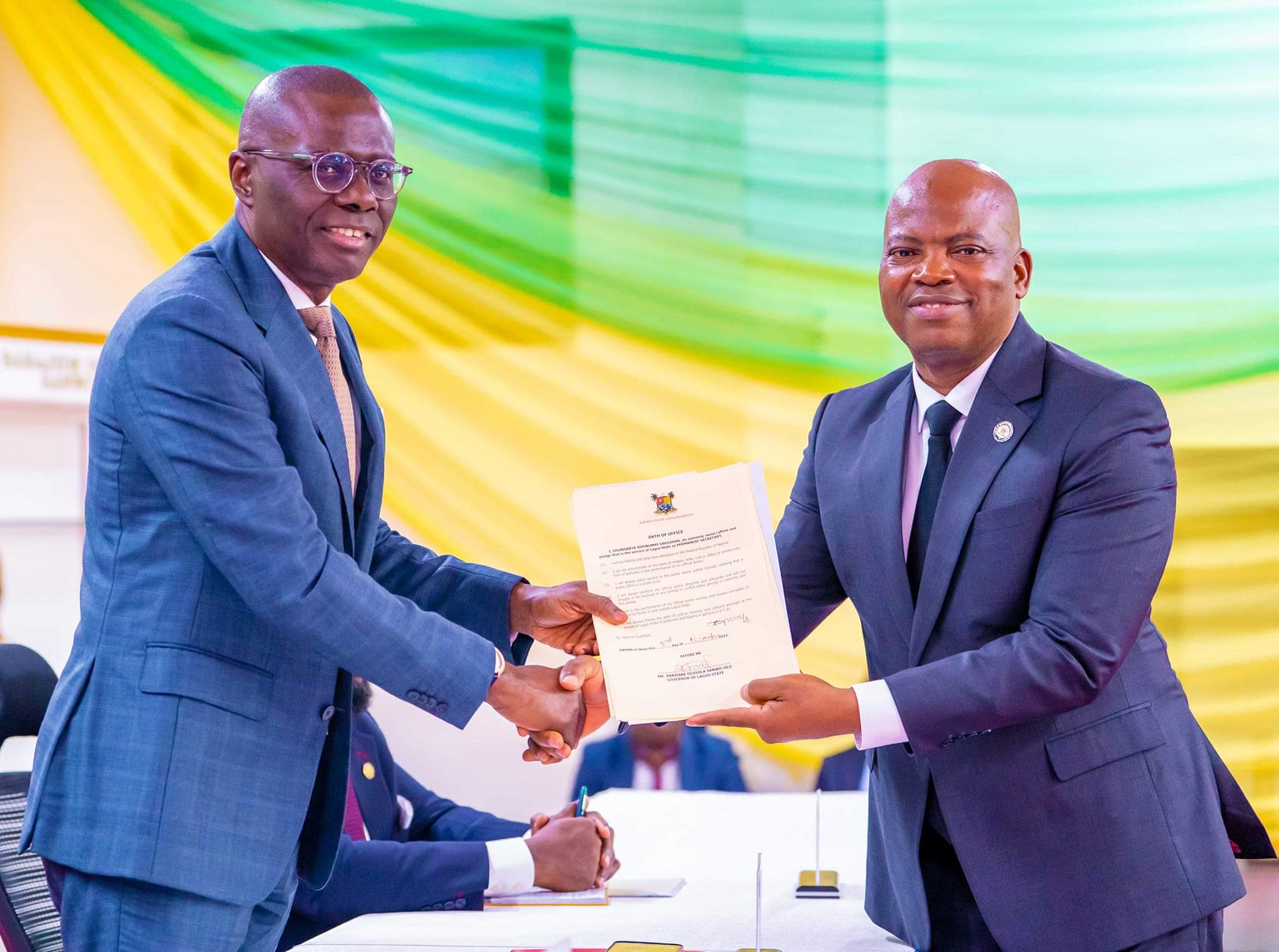 l-r: Governor of Lagos State, Mr. Babajide Sanwo-Olu presenting the Oath of Office to Mr. Gbolahan Ogunsanya as Permanent Secretary, Cabinet Office, during his swearing-in ceremony at the Lagos House, Alausa, Ikeja, on Friday, 03 November 2023. 