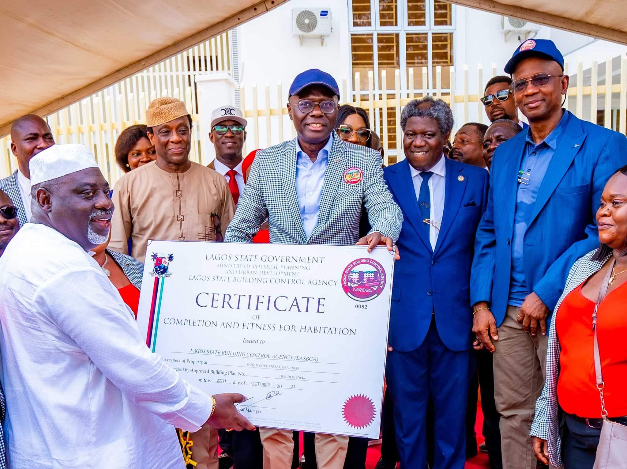 Lagos State Governor, Babajide Sanwo-Olu, presenting the Certificate of Completion and Fitness for Habitation to the LASBCA General Manager, Gbolahan Oki, at the new LASBCA headquarters