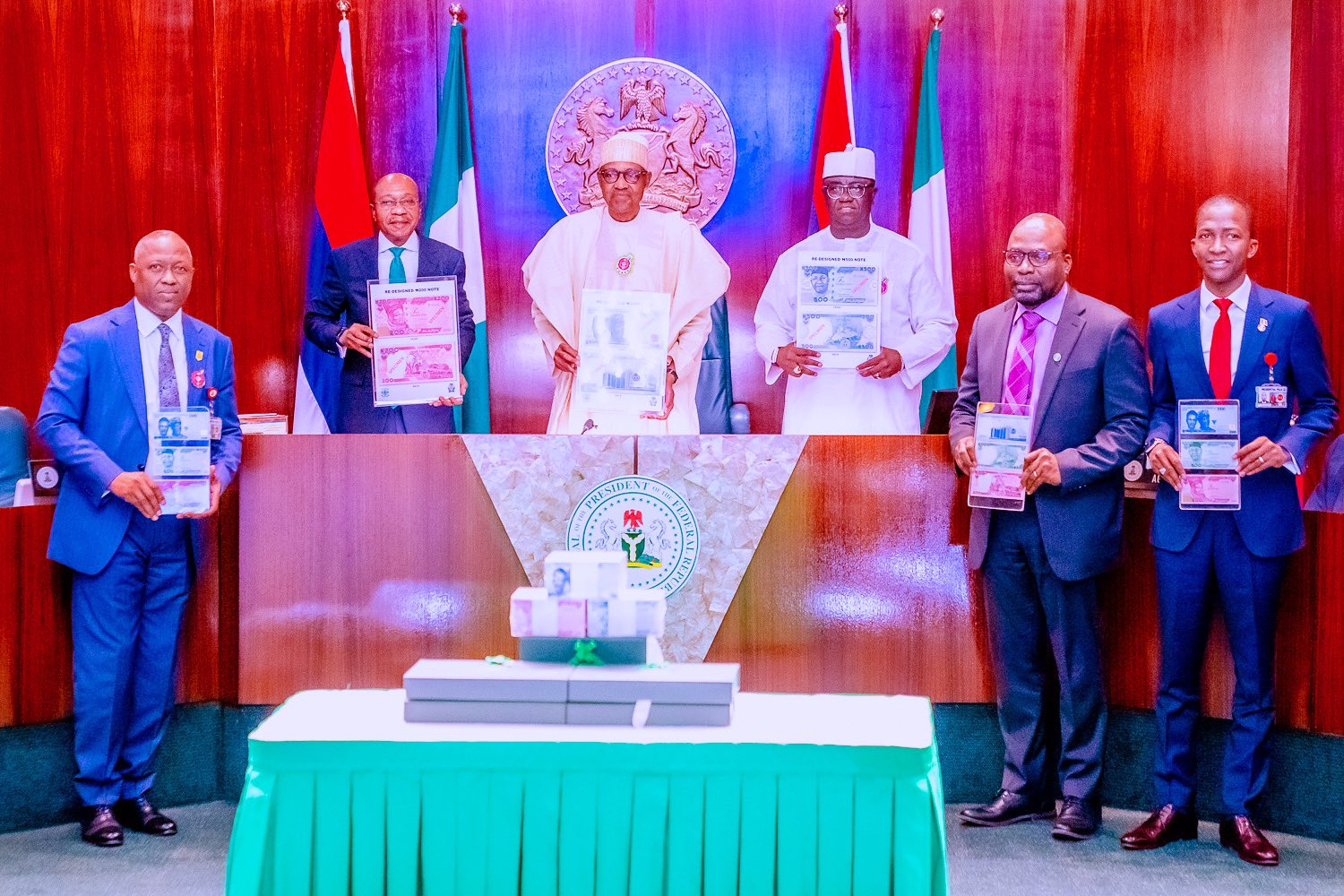 Embattled former CBN Governor, Godwin Emefiele, former President Muhammadu Buhari, and other government officials at the launch of the redesigned naira notes