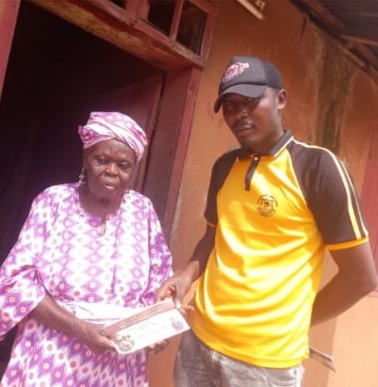 An elder in Epe gets February monthly stipend from members of Rep. Wale Raji's team