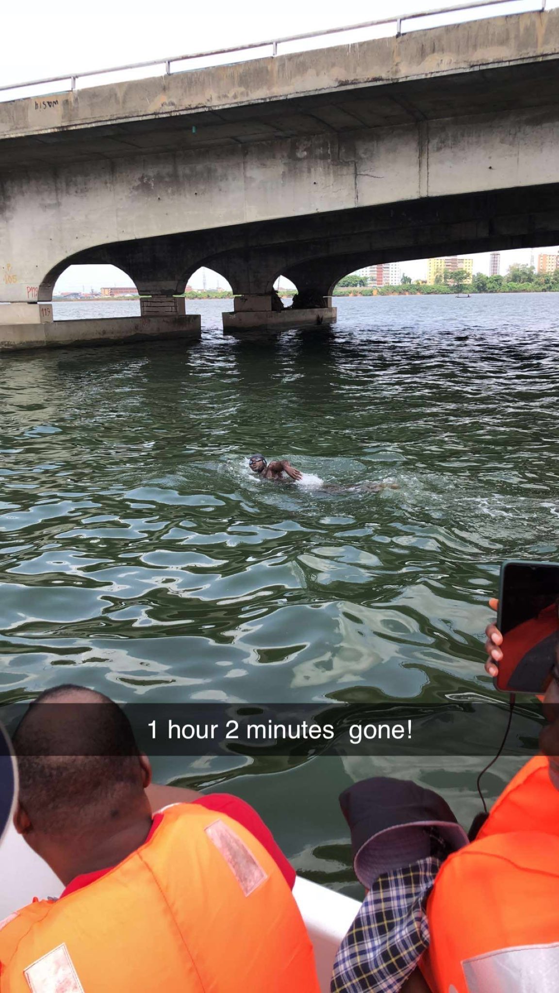 Coach Dreh on the 1 hour, 2 minutes mark during his swimming marathon across the Third Mainland Bridge, Lagos, on Saturday, March 30, 2024
