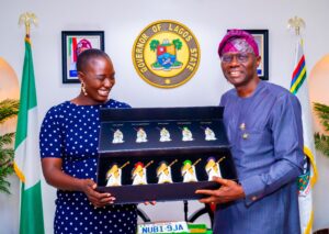 Governor Sanwo-Olu Presenting a state gift to London To Lagos Solo Driver Pelumi Nubi 