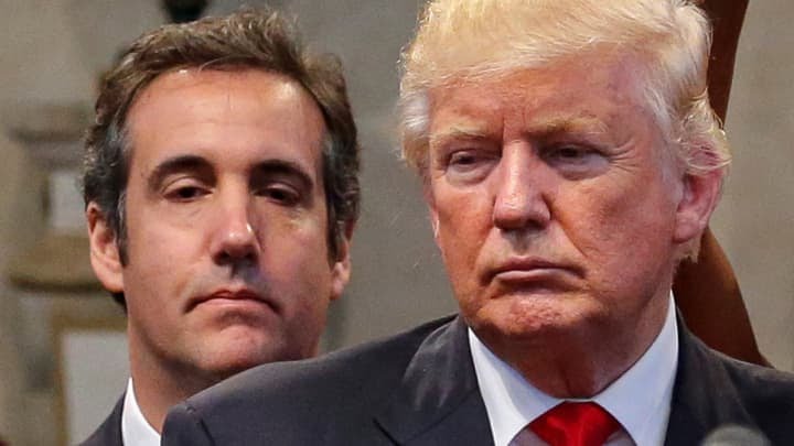 Former President Donald Trump's former personal attorney Michael Cohen stands behind Trump. (Photo: Jonathan Ernst | Reuters)