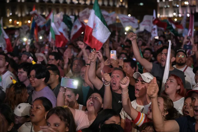 Supporters of Sheinbaum celebrate following the results of the general election at Zocalo Square in Mexico City, on June 3, 2024 [Yuri Cortez/AFP]