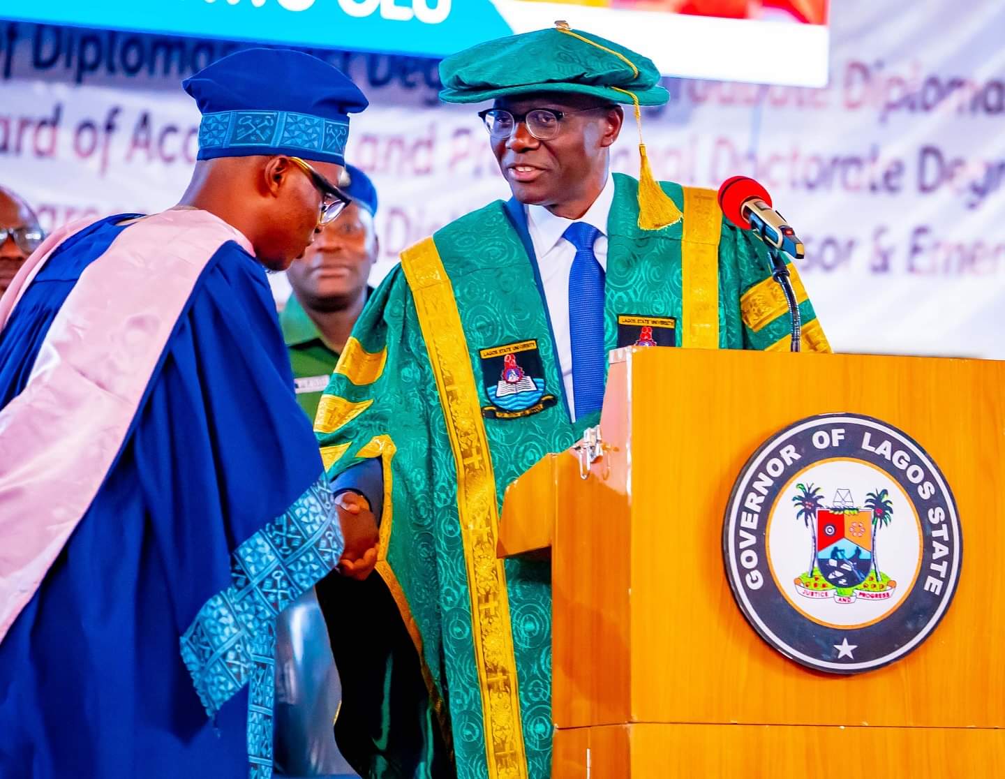 Olaniyi Mubaraq Olawale, LASU's Best Graduating Student receives a handshake from Lagos State Governor Babajide Sanwo-Olu