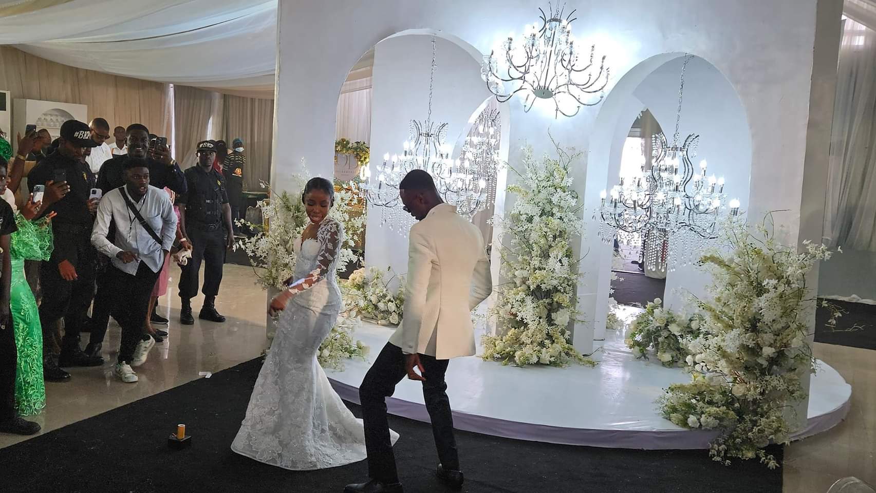 Groom Oladeji Bodunwa and bride Linda Onolemhemhen dancing at their wedding ceremony in Lagos