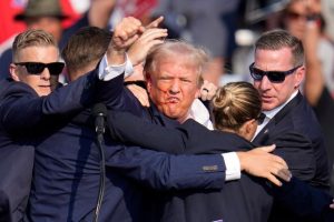 Former President of the United States Donald Trump swarmed by Secret Service agents after a bullet grazed his ear at a rally in Pennsylvania