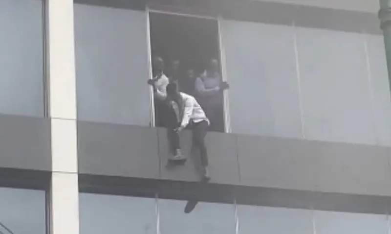 Workers at Afriland Towers jumping out of the building amid the fire incident on Tuesday, September 16, 2025
