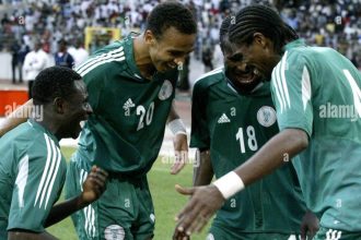 Nigeria striker Obafemi Martins, left, celebrates together with Osaze Odenwengie, second left, Christopher Obodo and Nwankwo Kanu in Abuja, Nigeria, Saturday Oct. 8 2005 during their World Cup 2006 qualifying match against Zimbabwe. Nigeria beat Zimbabwe 5-1 but still missed out on qualifying for the 2006 World Cup finals Saturday. (AP Photo/George Osodi)