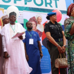 A policewoman carrying the bag of Titi Abubakar, the wife of former Vice President Atiku Abubakar at an event in Abuja in October 2022