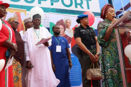 A policewoman carrying the bag of Titi Abubakar, the wife of former Vice President Atiku Abubakar at an event in Abuja in October 2022