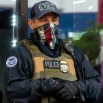 File photo of a masked ICE agent