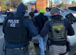 ICE agents taking some men into custody during a raid in Denver, Colorado