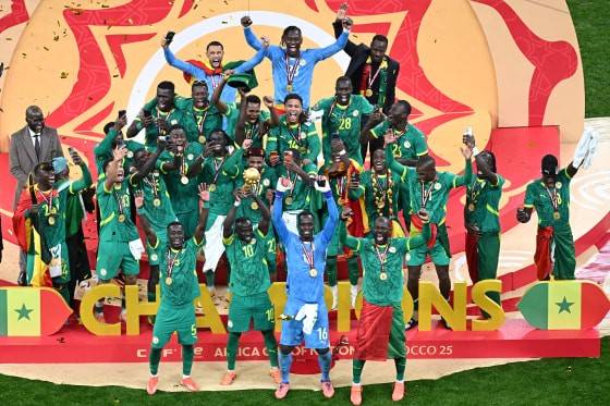 Senegal forward Sadio Mané holds up the trophy as he celebrates with his teammates after Senegal won the Africa Cup of Nations final against Morocco in Rabat on Sunday. (Photo: Sebastien Bozon / Getty Images)