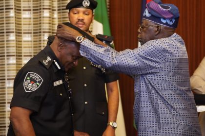 President Bola Tinubu decorating Ag. IGP Tunji Disu