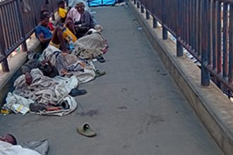 File photo of illegal settlers on a pedestrian bridge in Lagos