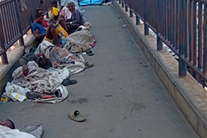 File photo of illegal settlers on a pedestrian bridge in Lagos