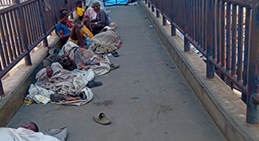 File photo of illegal settlers on a pedestrian bridge in Lagos