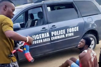 Screenshot of the video showing the incident in which the Delta police officer, ASP Nuhu Usman, staged the public execution of Mene Ogidi