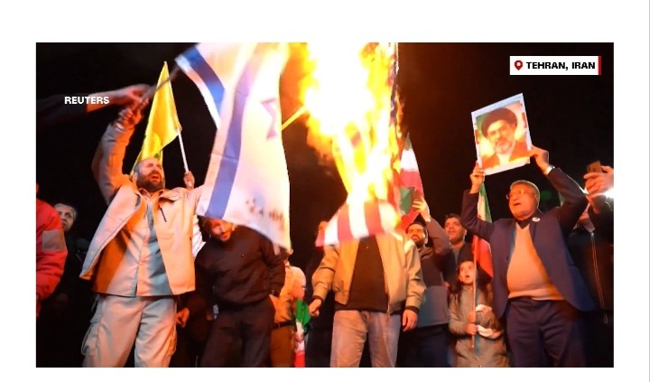 Tehran Protesters Burn US, Israeli Flags Amid Skepticism Over Newly Announced Ceasefire