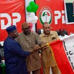 Sandy Onor being handed the PDP flag as the party's presidential candidate in the 2027 election