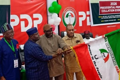 Sandy Onor being handed the PDP flag as the party's presidential candidate in the 2027 election