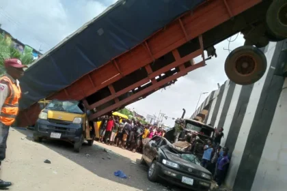Six Escape Death as Container-Laden Trailer Falls from Anambra Bridge
