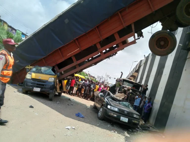 Six Escape Death as Container-Laden Trailer Falls from Anambra Bridge