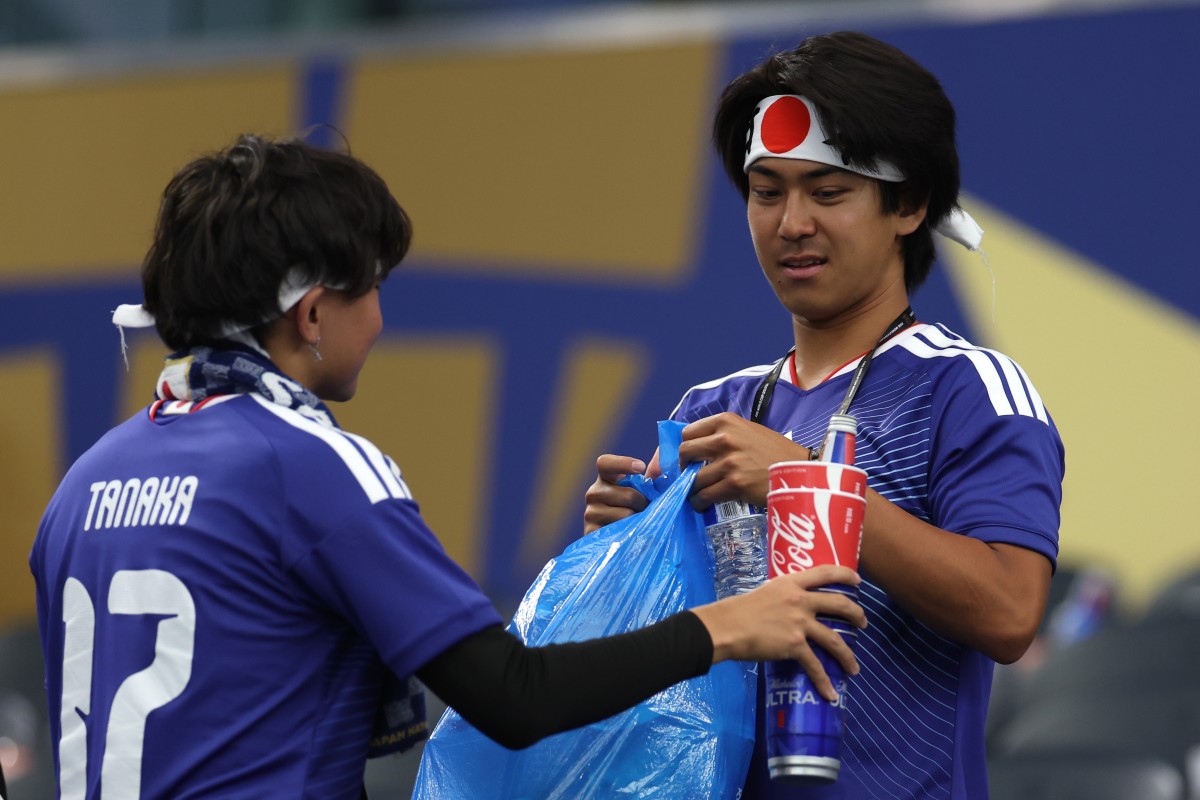 Japan fans tidy Dallas stadium after their 2-2 draw with Netherlands on Sunday