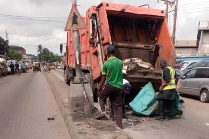 LAWMA intervention team members clearing up heaps of dumped waste from the median of the Egbeda–Idimu Road and Lawanson, Surulere corridor on Tuesday, June 16, 2026