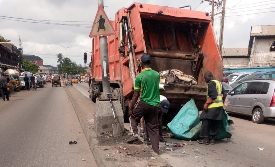 LAWMA intervention team members clearing up heaps of dumped waste from the median of the Egbeda–Idimu Road and Lawanson, Surulere corridor on Tuesday, June 16, 2026