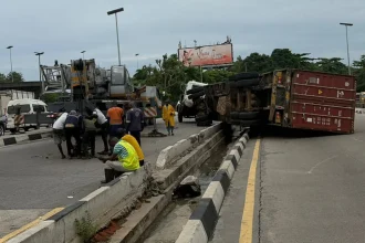 Two Motorists Escape Death as Container Truck Falls on Lagos Airport Road