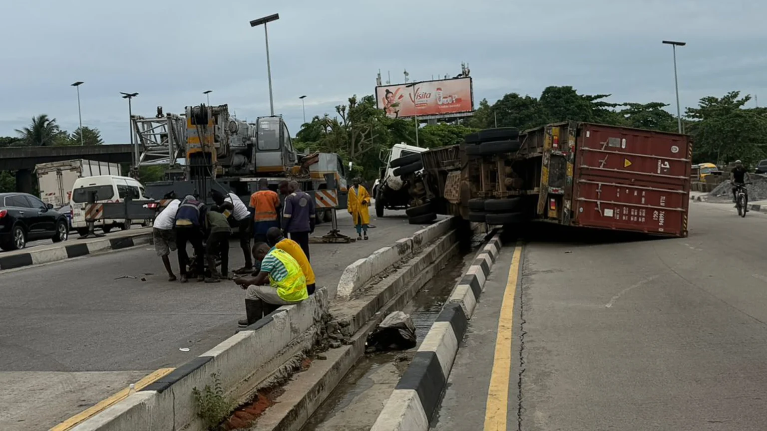 Two Motorists Escape Death as Container Truck Falls on Lagos Airport Road