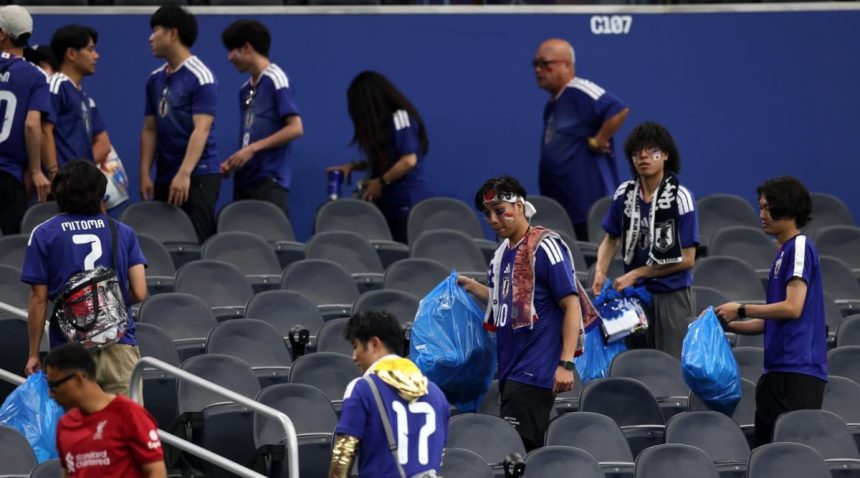 Japan fans tidy Dallas stadium after their 2-2 draw with Netherlands on Sunday