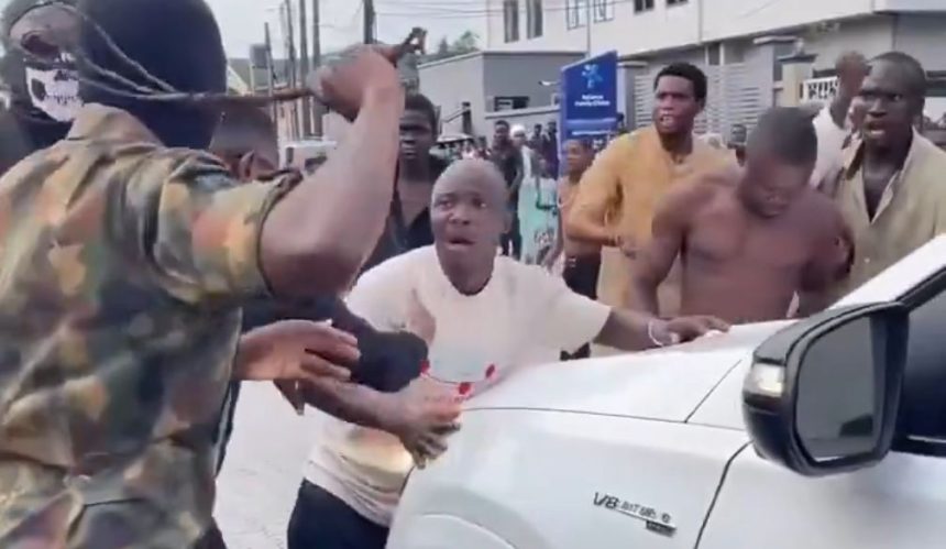 Screenshot from a video showing some young men widely described as agberos blocking a guest at Peller's wedding from passing until they give them money
